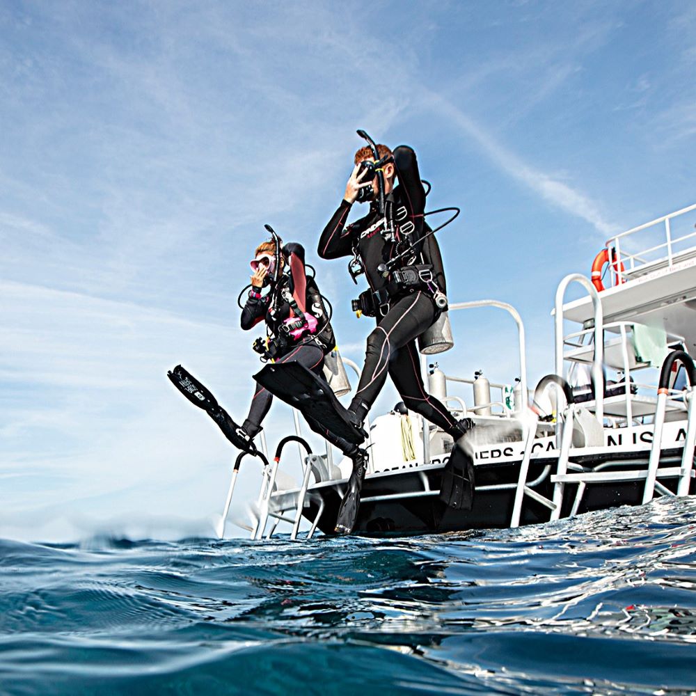 Diver adjusting rental scuba gear before a dive