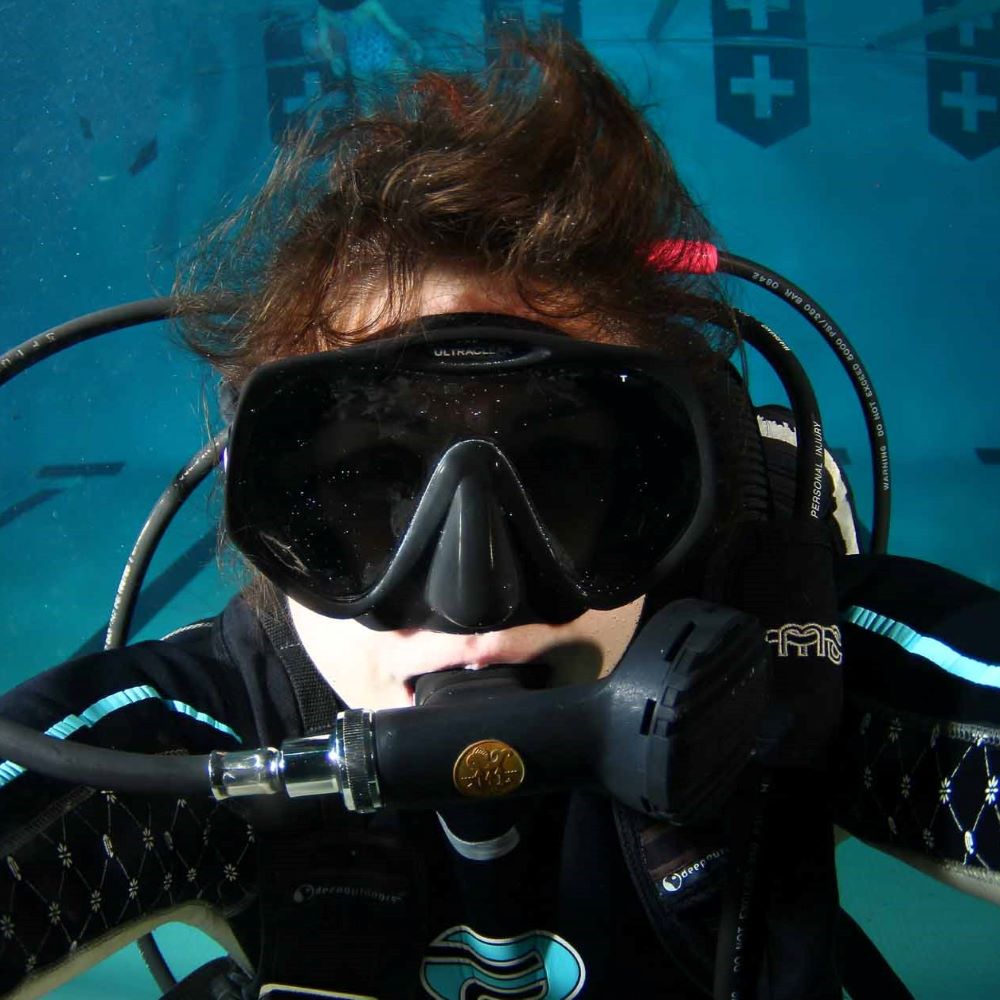 Diver checking their own familiar equipment